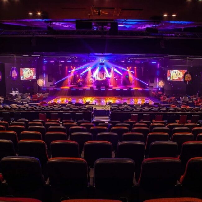 An expansive auditorium equipped with comfortable seating and a spacious stage.